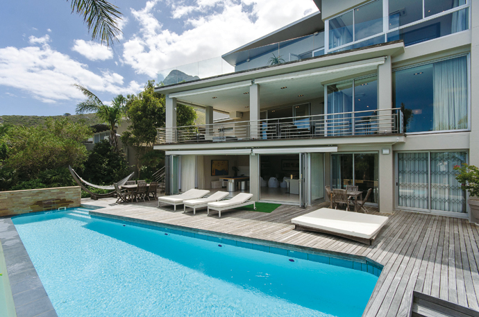 The partially covered deck is an ideal space for summer socialising and lounging by the pool while soaking up your surroundings. There’s also a garden below.