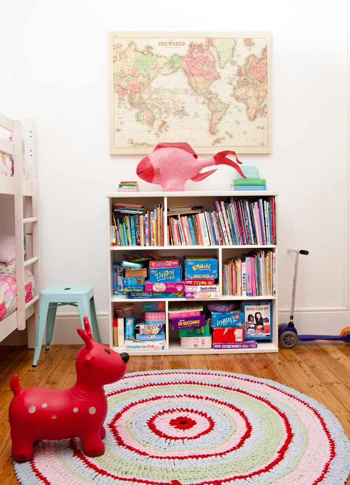 From the girls’ bedroom wall, a canvas map from Typo tells tales of faraway countries. The bright mat is a crochet T-shirt work found at Merry Pop Ins, and the fish is from Heartworks, bought when Cara was pregnant with Idana.   
