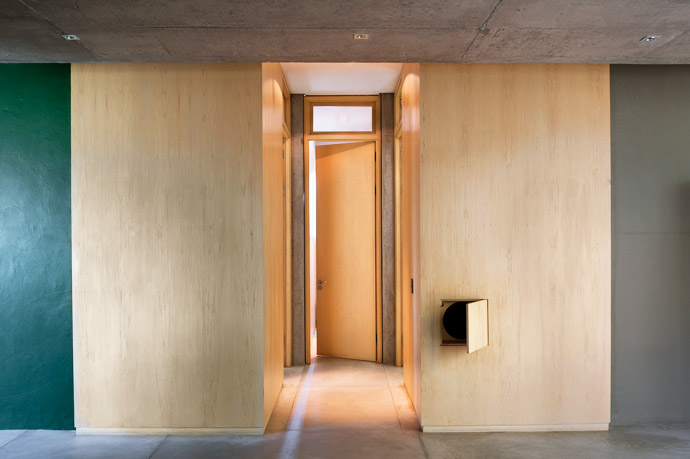 Floor-to-ceiling white birch timber panels wrap around the passage leading up to the children’s bedrooms, complete with a handy laundry chute that transforms everyday chores into child’s play.
