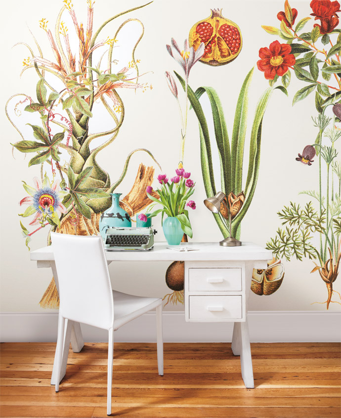 Cara’s workspace doubles as a spare room. The Botanical wallpaper, from the Cara Saven Collection, was custom-designed. Perching on the small desk, custom-made by a carpenter in Woodstock, are two turquoise market-find vases flanked by a Lisa Firer work. The old typewriter is a prop used in a film by Marvin’s company, the copper lamp is from Mr Price and the chair is from Coricraft.