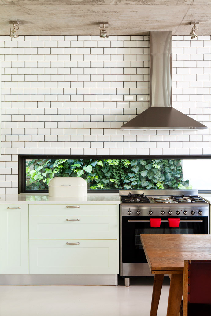 Cara designed the kitchen herself and had the bespoke cupboards painted in Plascon’s Mint Whisper, her favourite colour. A cleverly placed window lets in light and nature. The subway tiles are from The Tile House.  
