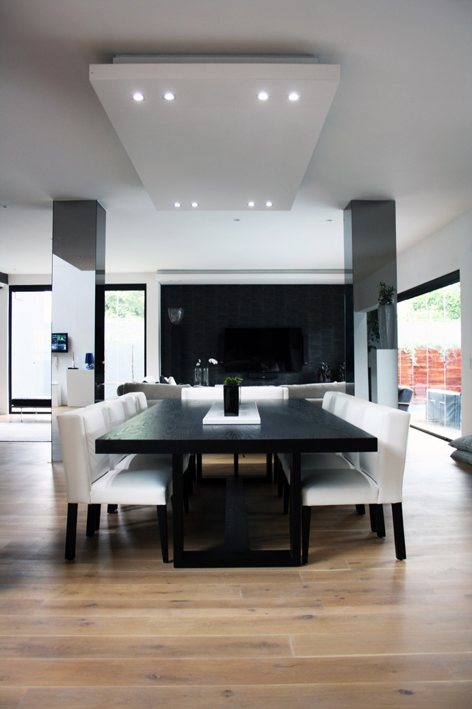 A large bespoke ebony-stained oak dining table takes centre stage in the living area.
