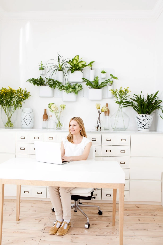 Dr Lulu Beyers in her consultation room. The plants and flowers (in a wall planter from Urbio and vases from Weylandts) add a touch of nature to the interior. The Chinese medicine dispensary was custom-made.  
