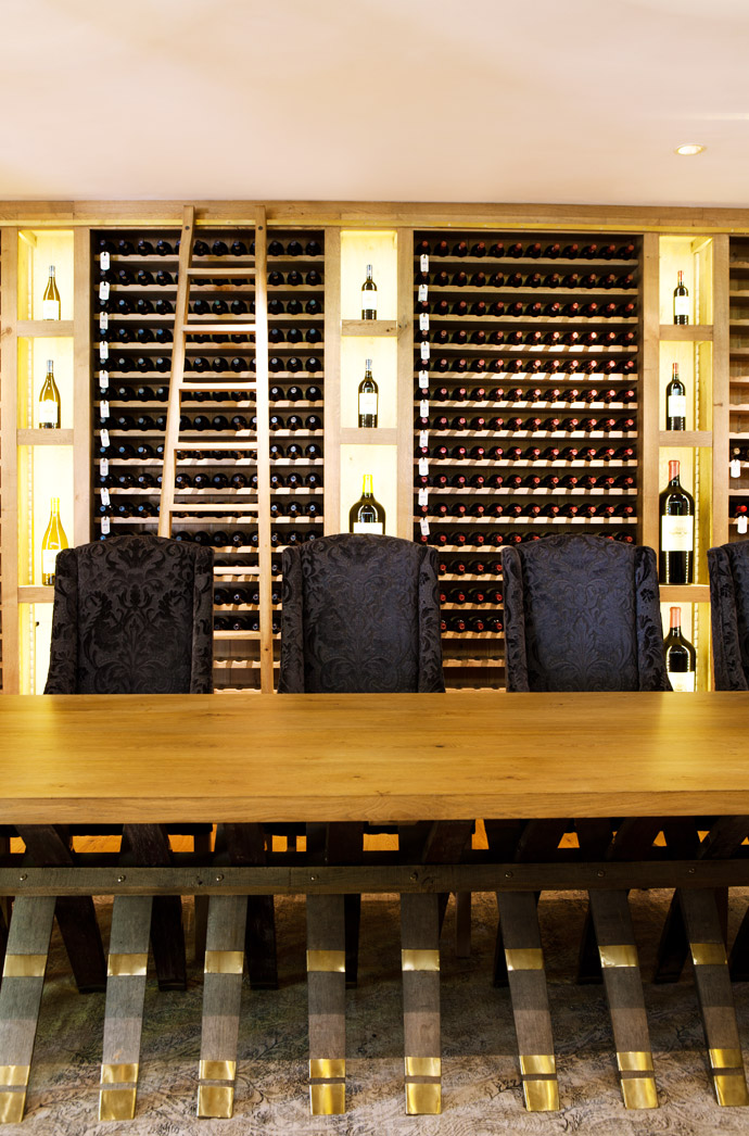 The wine shelves and the table were designed by Christo Barnard and made by Pierre Cronje. The wing chairs are from Wunders.
