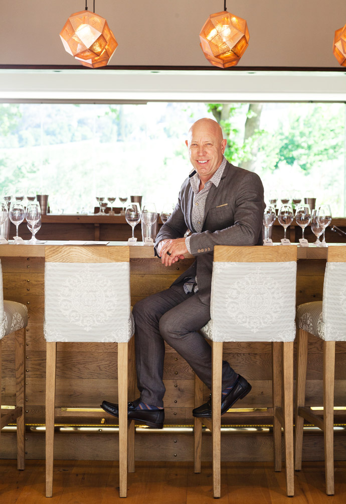 The oval wine-tasting counter and the other wooden furniture, inside and outside, are all made of French oak by master craftsman Pierre Cronje. The floors are all oak, and the poplar beams are original – one beam was used as a mantelpiece. The lights above the tasting counter are by Tom Dixon, and the baskets for firewood on either side of the fireplace were designed by Christo. The drawings are of the two founders, Dr Anton Rupert and Baron Edmond de Rothschild.