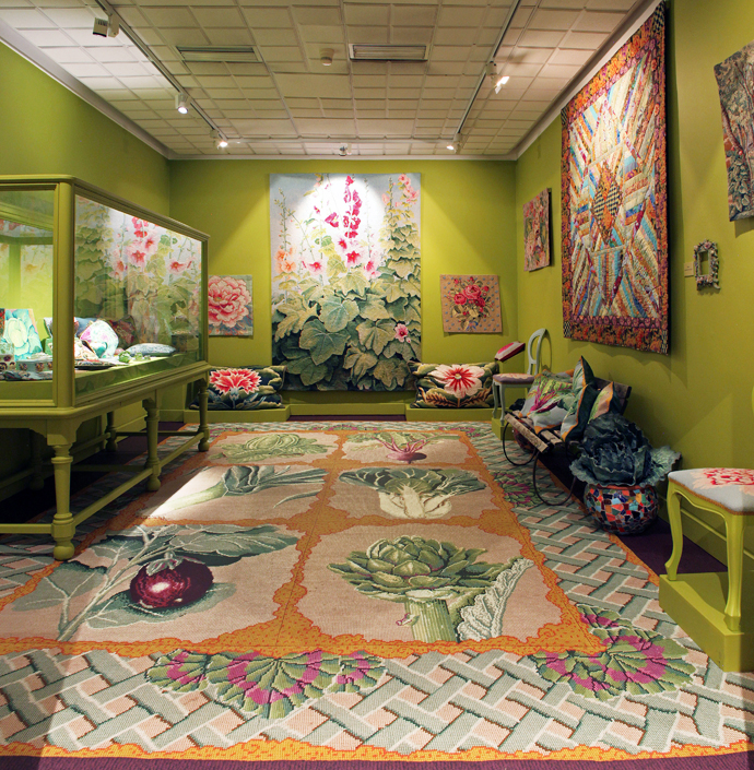 With walls in Kaffe’s distinctive shade of green, the hollyhock tapestry and floral cushions from his design for As You Like It by the Royal Shakespeare Company seem to vibrate under the theatrical lighting. The carpet is a digital print based on one of Kaffe’s needlepoint designs.