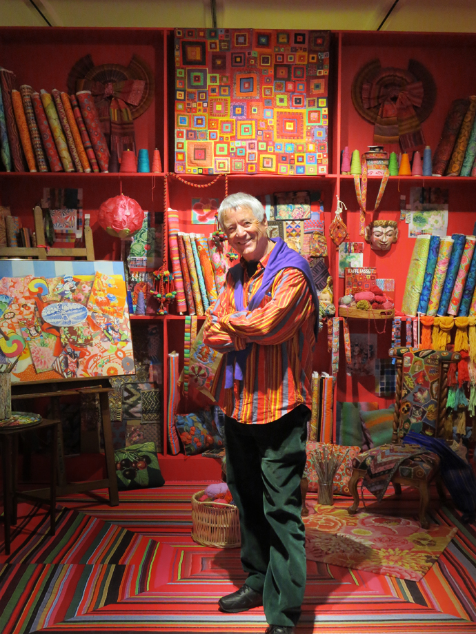 Kaffe Fassett in the centerpiece of the exhibition, a recreation of his studio that is an explosion of objects, fabrics, memorabilia, samples and sketches, and the inspiration for all the work he has created in the other rooms.