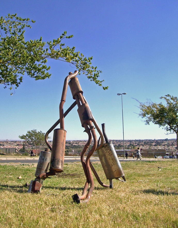 DIY signage for informal exhaust pipe repairs.