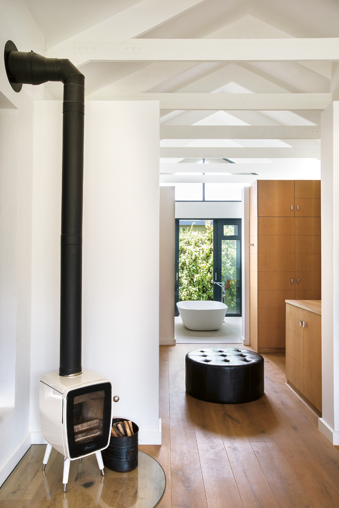 The house is so well insulated that a small free-standing fireplace is all that’s needed to heat the large main bedroom.
