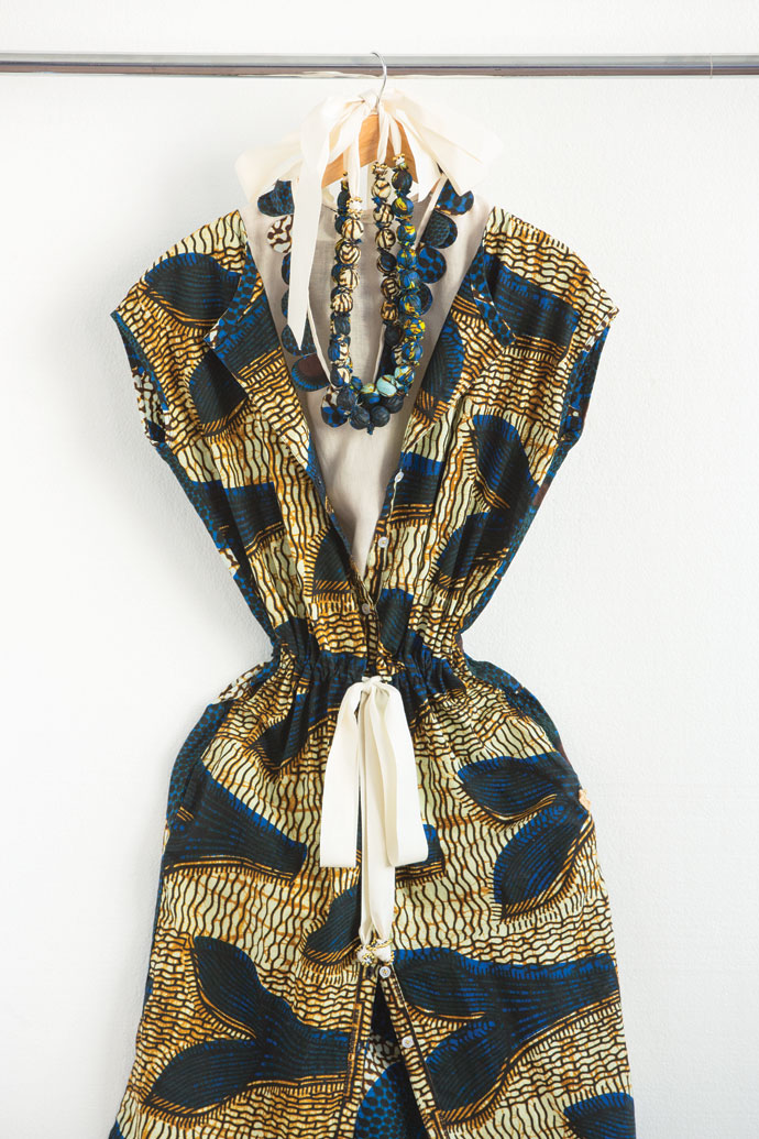 Wax-print cotton shift dress R1 300, sleeveless linen top with petal detail, R1 000, and covered bead necklace, R450.