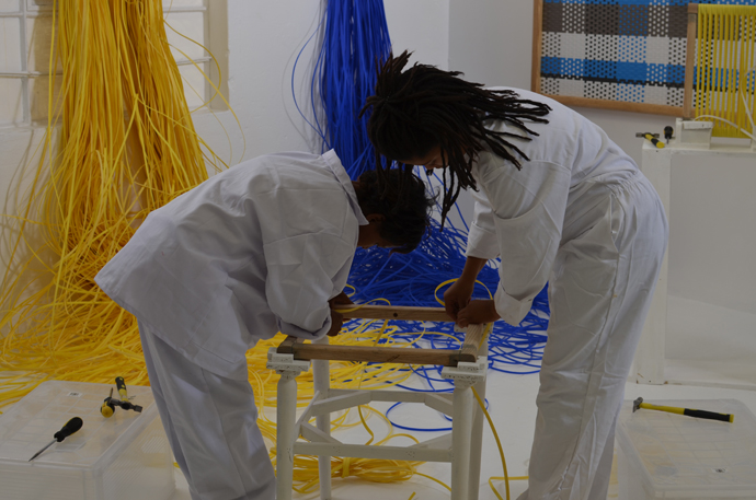 Woven panel and chair by John Vogel. The weavers, below from left, are Lizelle Andrews, Tishina Watson and Charnielle Davids.  Image credit: Tracy Lynch.
