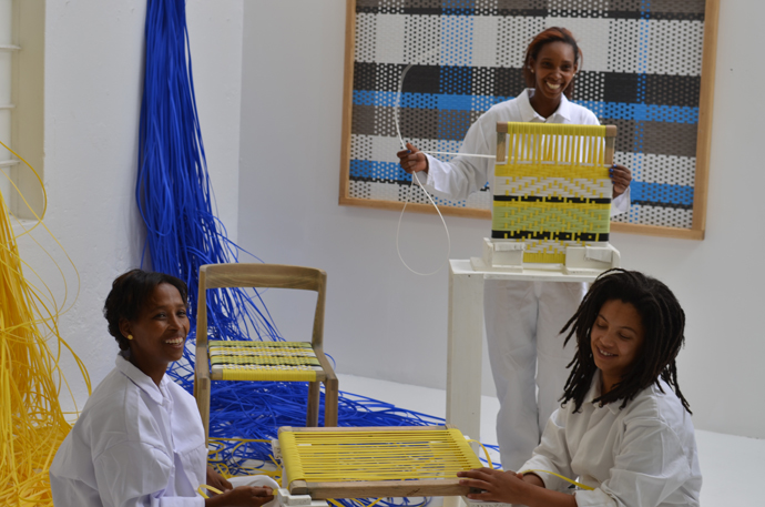 Woven panel and chair by John Vogel. The weavers, below from left, are Lizelle Andrews, Tishina Watson and Charnielle Davids. Image credit: Tracy Lynch.