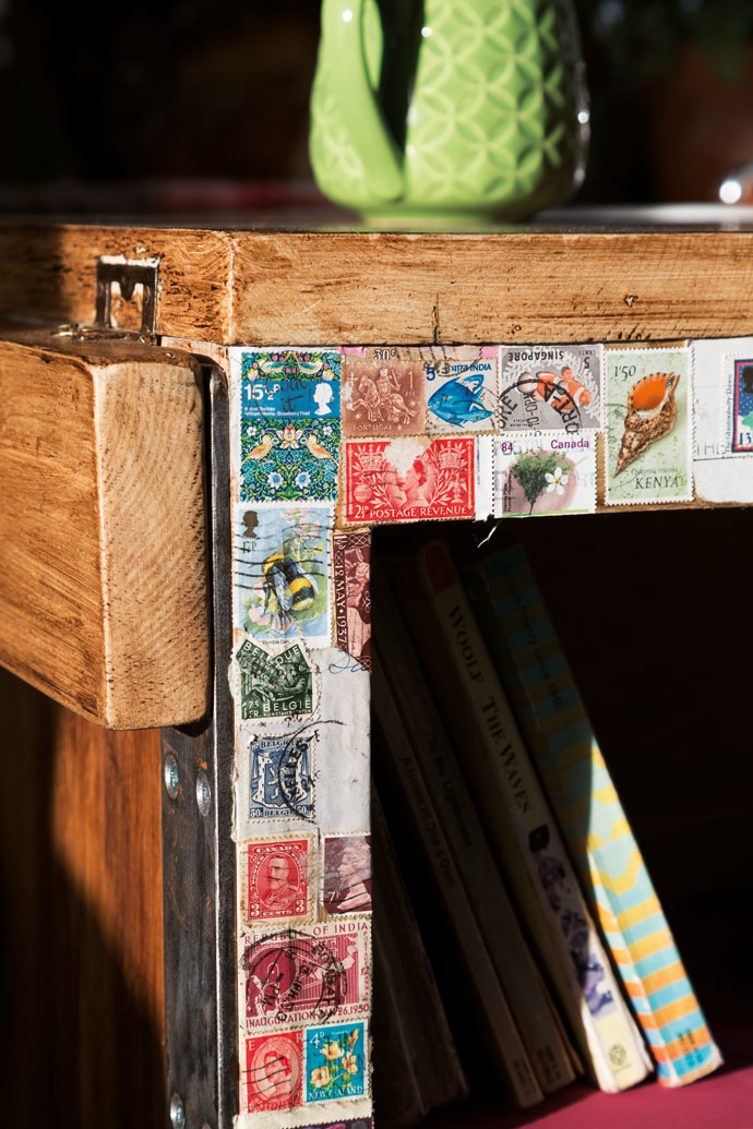 Rather than keep their old collection of loose stamps out of sight in a box somewhere they used them as a decorative edging for the shelving unit, each one stuck on with glue and then carefully sealed.