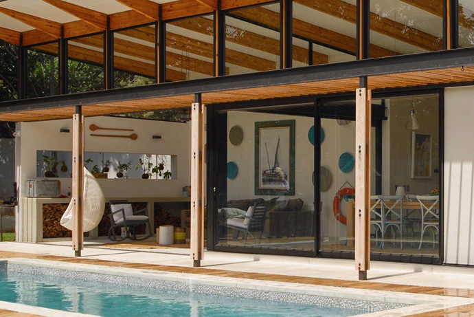 Outdoor living spaces can bring traditionally indoor gathering areas such as family and dining rooms outside, often with the swimming pool as the focal point.