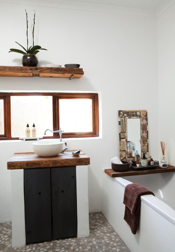 Sleepers were used to create the shelving and countertop in the bathroom. Cornel tiled the pebble floor. 
