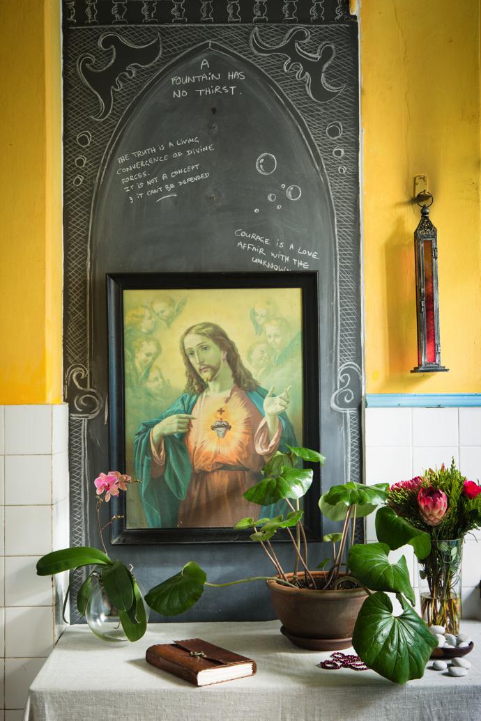 A doorway to the hotel scullery was boarded up and made into a chalkboard. The Jesus painting and the Moroccan lantern are from Kalk Bay shops Catacombs and Papagayo, respectively.