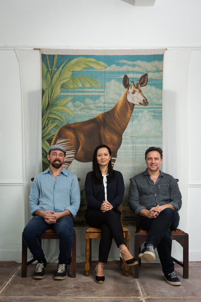 From left, Harem with his partners in the HOT COFFEE venture, Eed  and Tim Harbich, in front of a linen wallhanging featuring an okapi. Image by Jan Ras.