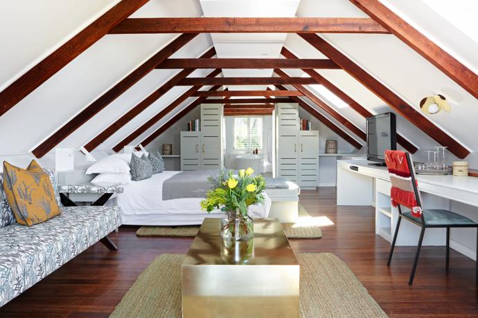 Cool and contemporary in feel, all the rooms feature neutral tones, accented with textures and pops of colour. The bespoke bench is by Guideline, upholstered in Alexis Barrell fabrics. The jute rugs and brass coffee table are by Studio No. 19, and the bedside lights and tapestry chair are by Bofred.