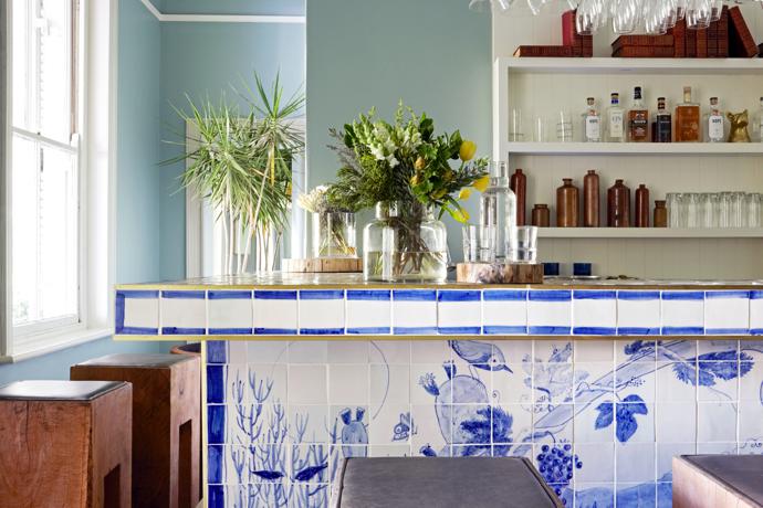 The tiled bar was custom-made by Michael Chandler. The bespoke carved bar stools are by Guideline.