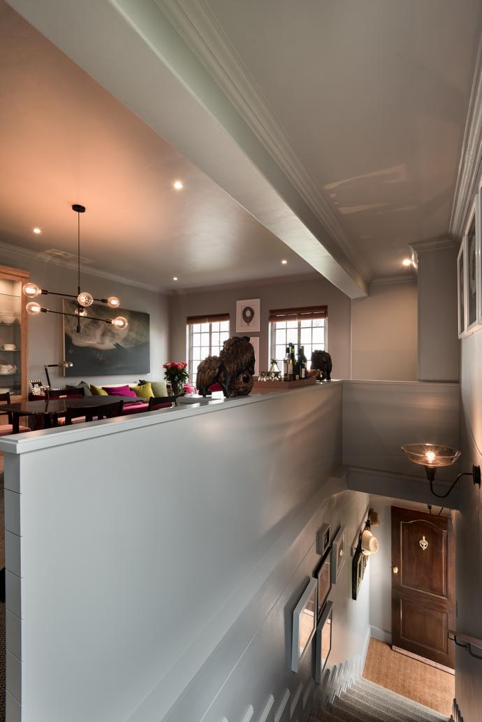 Boxing in the unsightly balustrade with cladding provided the backbone for a new sequence of cupboards, used to house dry foodstuffs, pots and pans. Lesley says the dining table was stored in the laundry for years until Astrid gave it a new lease of life with a set of chairs to match. The light is from Weylandts.