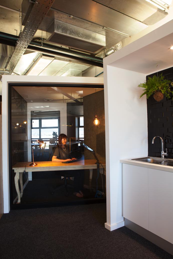 MariaCowie working at an oak table with solid timber legs that shows Pure Design’s classical design side.