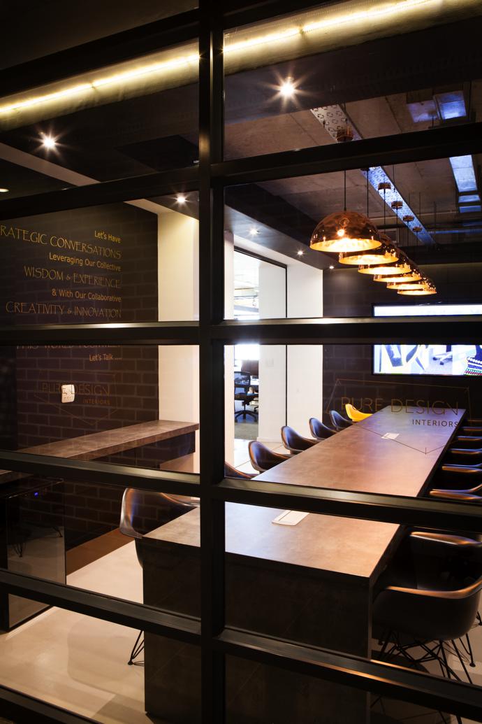 The boardroom with its custom- made concrete table compliments the 1950s-inspired chairs.