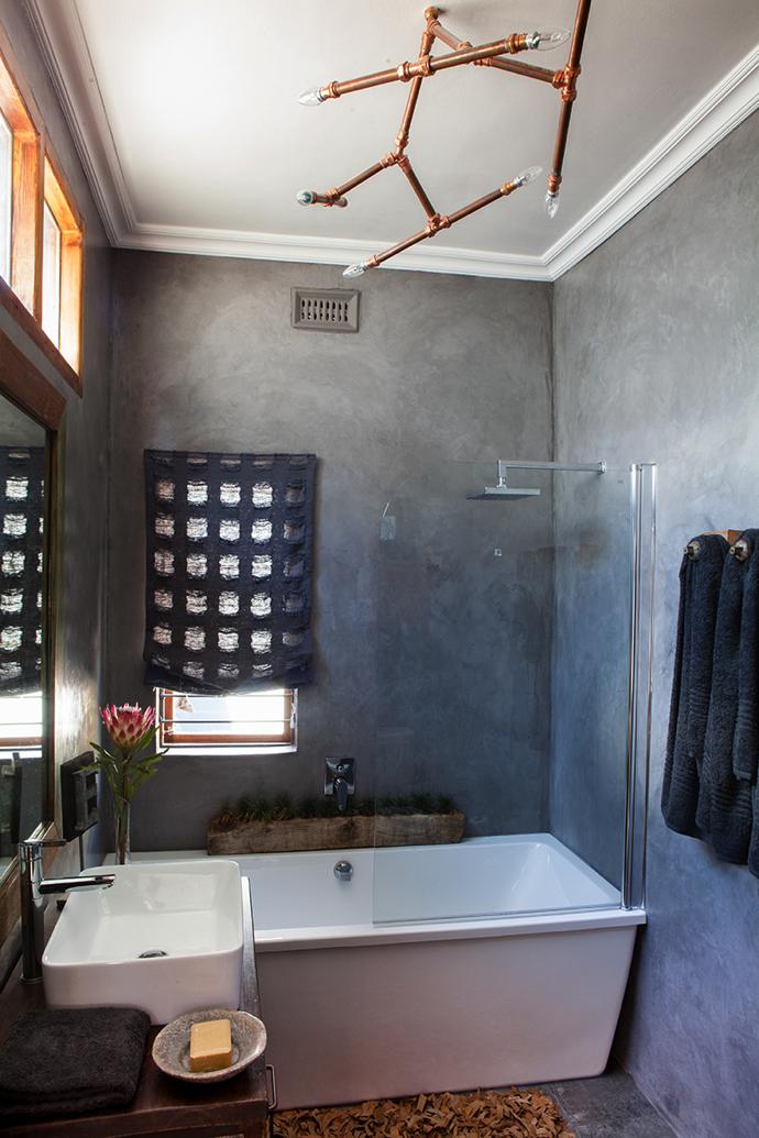 The freestanding sink, bath and tap are from Tiletoria, and the linen curtain was made by The J Factor using fabric from The Fabric House.