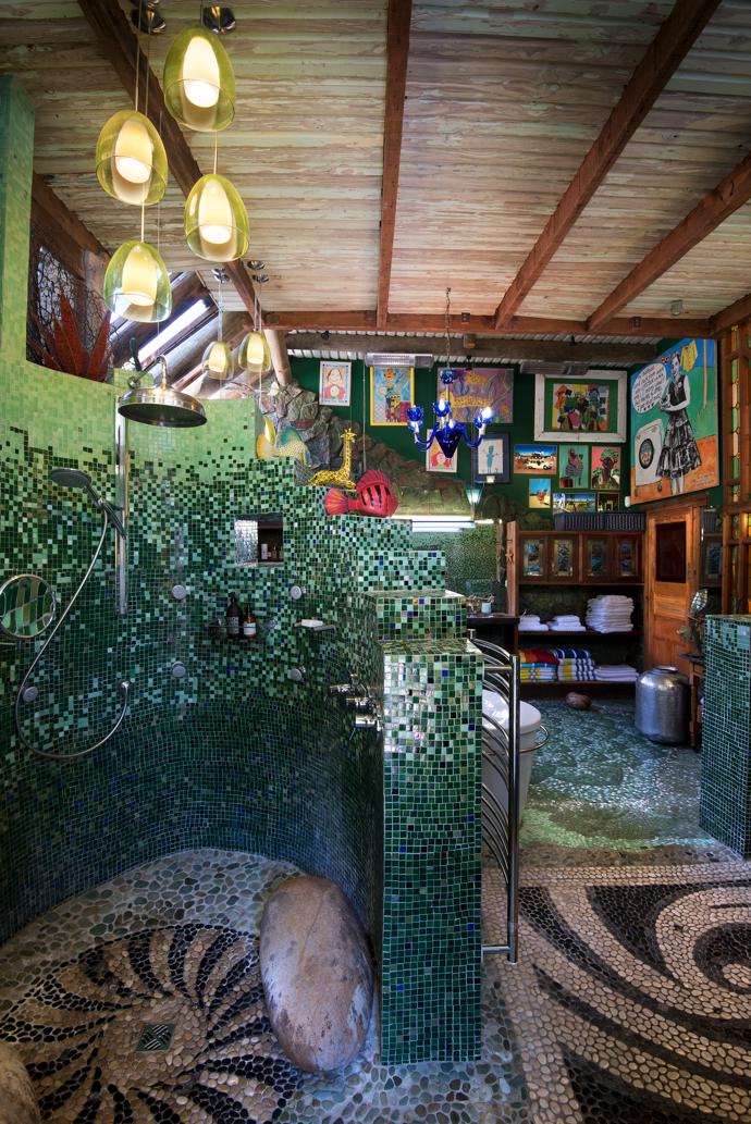 Mosaics in classic shades of green in one of the spacious, light filled bathrooms create the feel of a traditional hammam. The artworks are from Mark Valentine’s Amatuli, and the pendant lights were bought on travels to fairs in Italy and France.