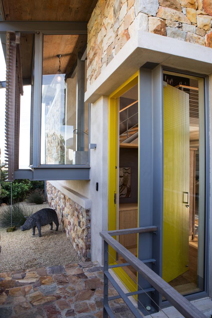 Once you have entered the gate and walked across what seems like a moat, you come to a yellow door, which leads you into the communal area where the two wings of the house meet. The wire pig outside the front door is from L’Orangerie.