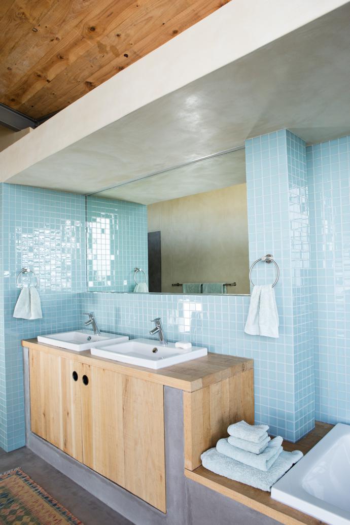 A team of local artisans, coordinated by Pringle Bay contractors Martin and Theresa Helmbold, was involved in everything from the carpentry to the tiling. In the main bathroom, the French oak vanity and glass mosaic tiles are from Douglas Jones.