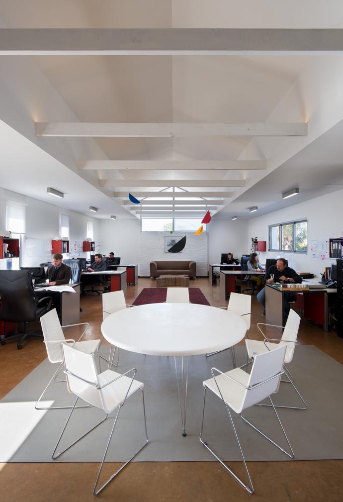 Sunlight pours into the first-floor studio from all sides. The chairs are from Sean Williams Contracts and the mobile was bought at the museum shop at the Peggy Guggenheim Collection in Venice.