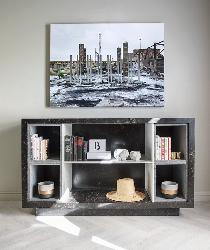 A Caesarstone shelving unit in Rugged Concrete and a photograph by Paris Brummer printed on canvas reinforce the concrete jungle theme.