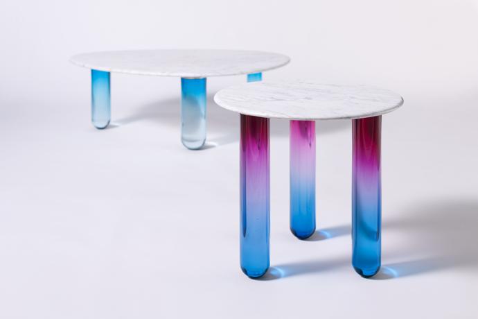 Ini’s Galilee and Orion tables from the Secret Garden collection have coloured glass legs and solid marble tops.