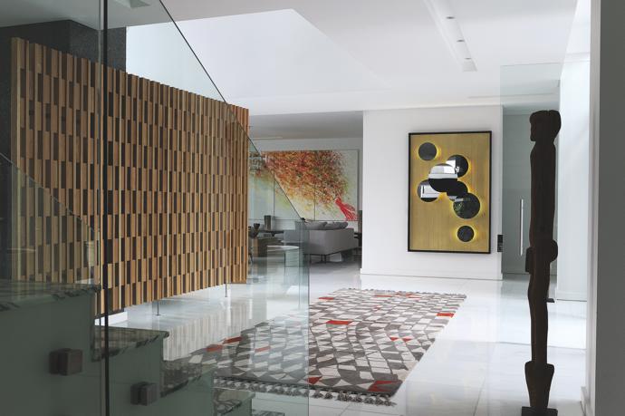 The brass clad Solar Mirror in the entrance, which also features a Bongo Tribal statue and custom Berber rug, was designed by OKHA Director Adam Court who also designed the screen.