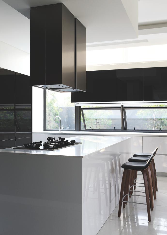 The functional design of the slick, monochromatic kitchen ensures only the necessary equipment is in sight. 