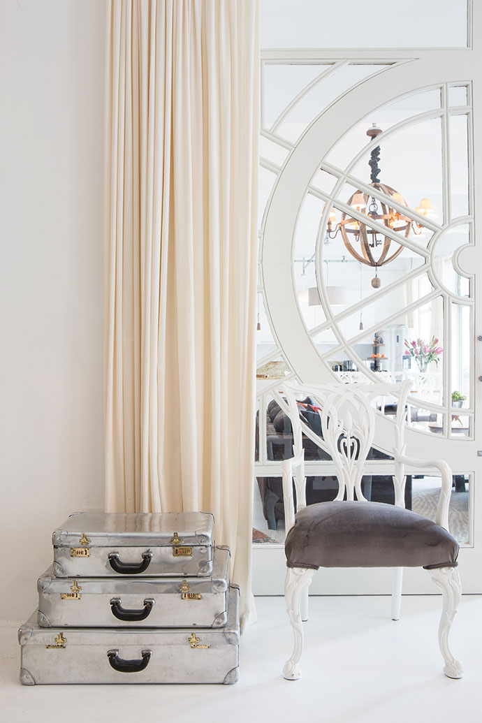 The enormous doors in a corner of the bedroom are repurposed 1930s windows of Belgian origin, and the suitcases were bought in the south of France. Inside the ribbed orb pendant lamp that illuminates the lounge hangs a set of huge old keys from a Georgian country house in Scotland.