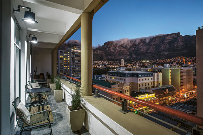 The incredible view of Table Mountain from the Pauls’ enormous balcony. Brian used Champagne buckets to make the top-hat lights for the exterior of Cecile’s vintage shop in Edinburgh.