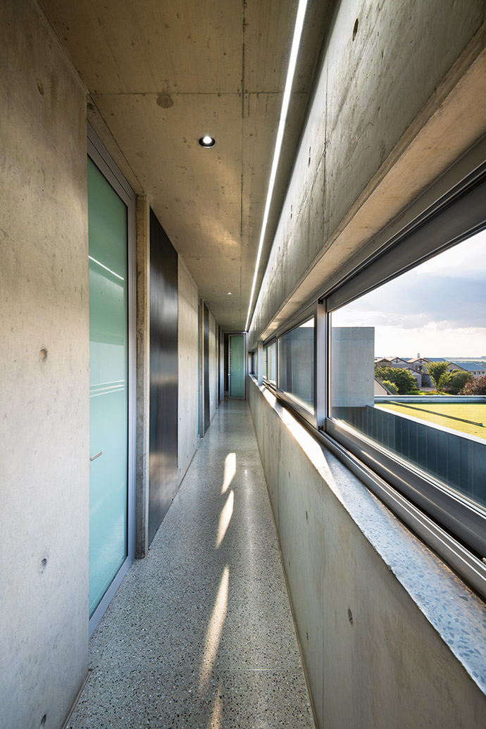 The balau footpath is echoed by a concrete roof overhead and framed by Artevia concrete paving.