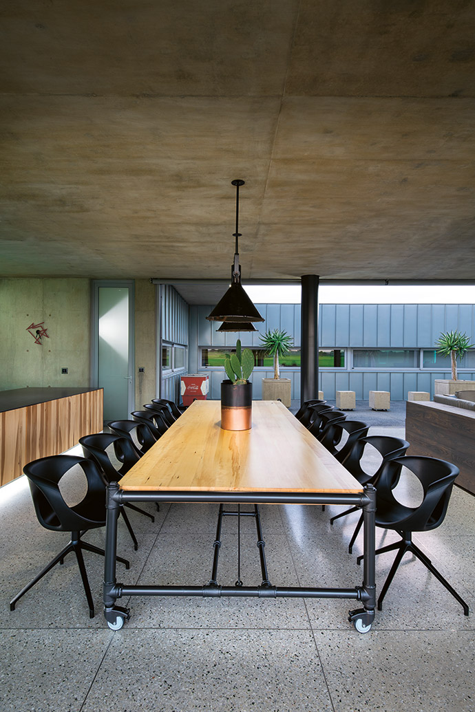 As an electrical contractor, Chaka was able to do all of the steelwork in the house himself. He made these pendant lights, and he made the dining table out of plumbing pipes and poplar. The chairs are from Comfort Creations.