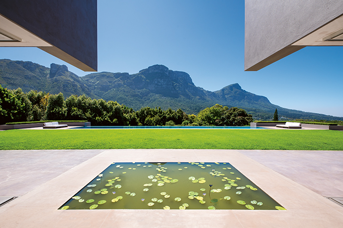 Water is a prominent feature, from the outside channels fringing the front of the home to this picturesque pond.