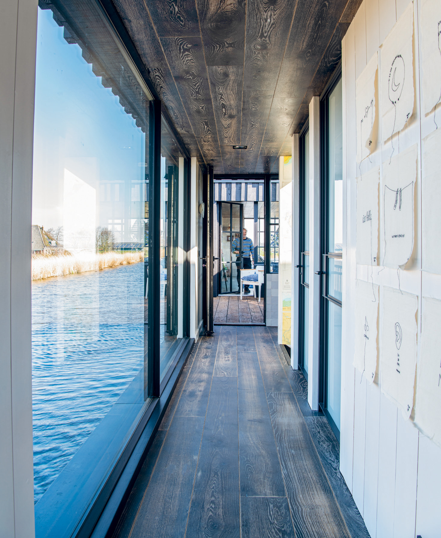 A window-lined passage leads to the kitchen and dining area, which opens up to an outside terrace.