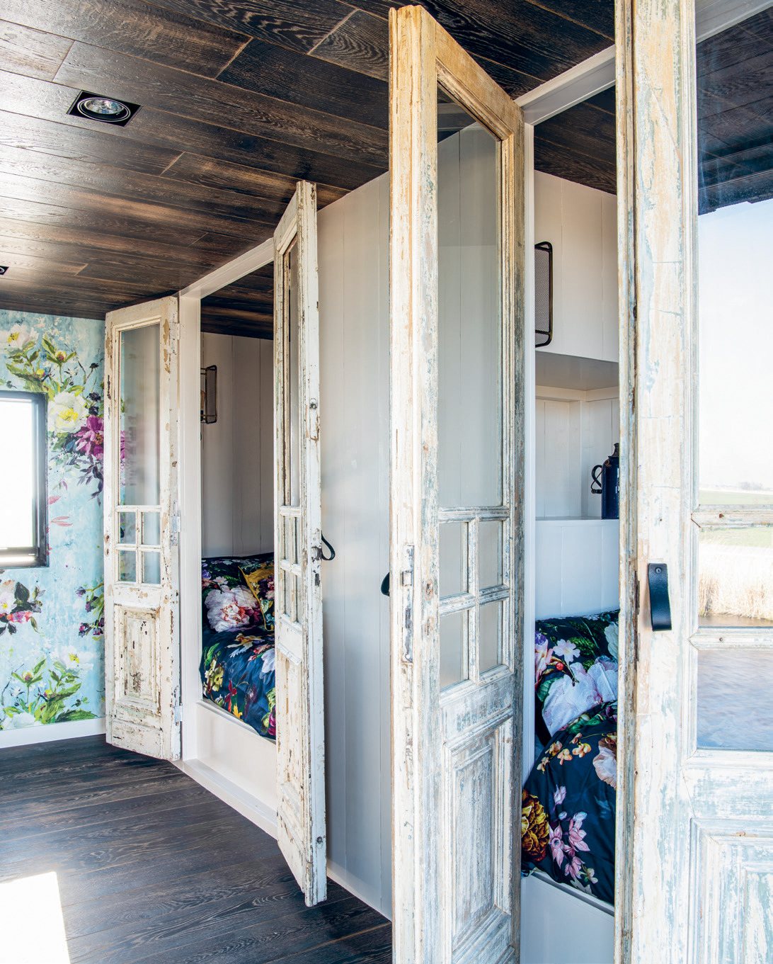 Clever “bed boxes”, with vintage wooden Egyptian doors for privacy, offer ample sleeping space for visiting family and friends.