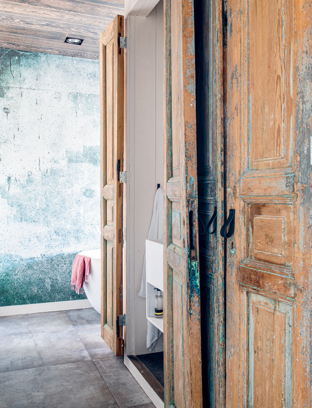 Vintage wooden Egyptian doors are used throughout the space.