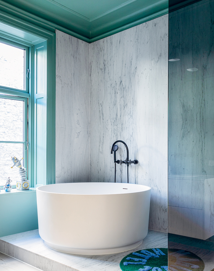 One the home’s three bathrooms features a round bathtub by Agape.