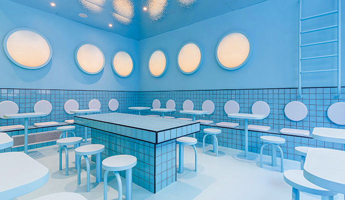 Creative consultancy Masquespacio’s design for a Bun Burgers outlet in Turin, Italy challenges the typical interior aesthetic of hamburger restaurant chains with sophistication and a touch of fun