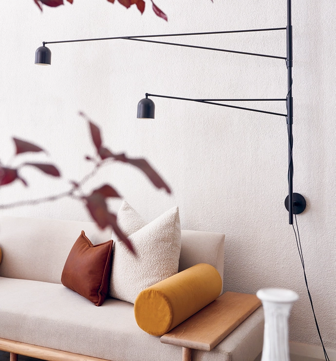 The Awkward wall light hangs over a Tengile sofa.
