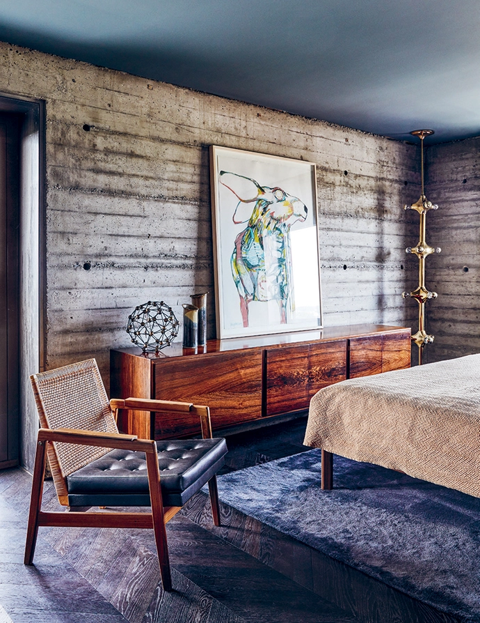 In one of the guest rooms, an artwork from Galerie Nasty Alice sits atop a vintage rosewood sideboard.