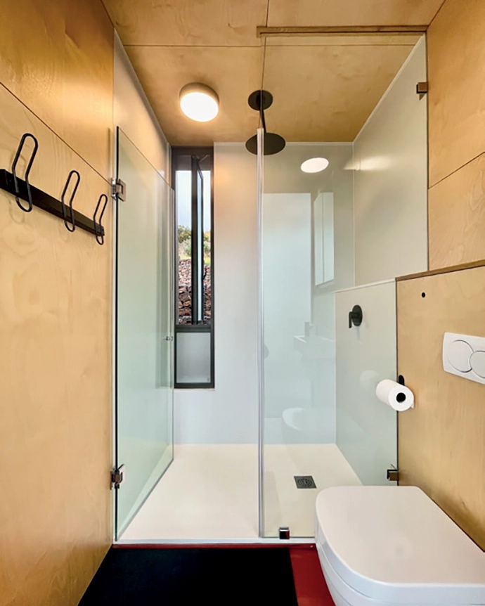 The bedrooms have double-glazed sliding doors, and include fi ttings such as Pedersen + Lennard’s Stockholm wall hooks, Hoi P’loy’s Signature Swivel wall sconce, and Mungo’s bed linen and throws.