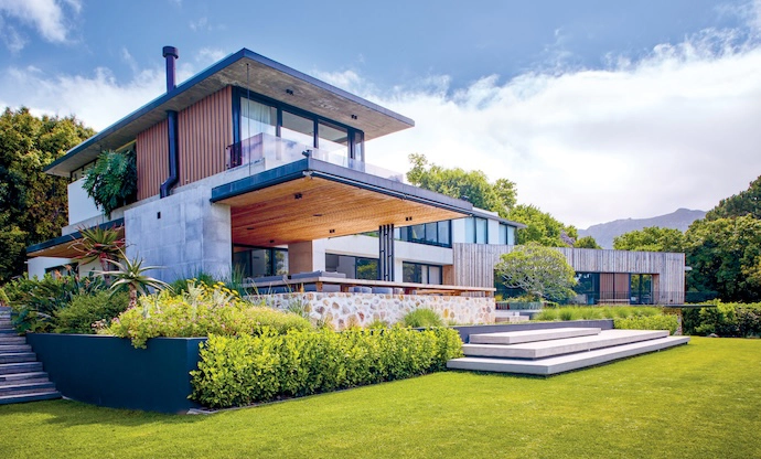 The renovated residence is immediately iconic thanks to two slabs of concrete cantilevering dramatically off the front elevation.