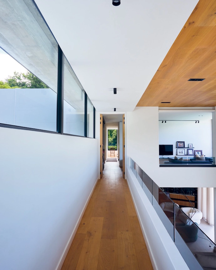 The mezzanine walkway offers a bird’s-eye view onto the living area below, and a peek into the pyjama lounge upstairs.